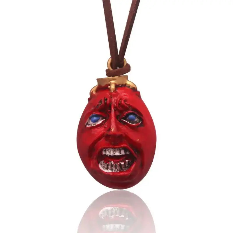 Berserk griffith behelit pendant necklace with red glossy face blue eyes and teeth on brown leather zinc alloy cord