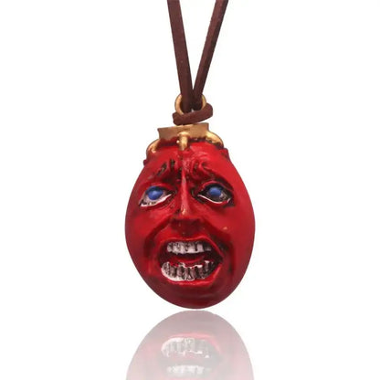 Berserk griffith behelit pendant necklace with red glossy face blue eyes and teeth on brown leather zinc alloy cord