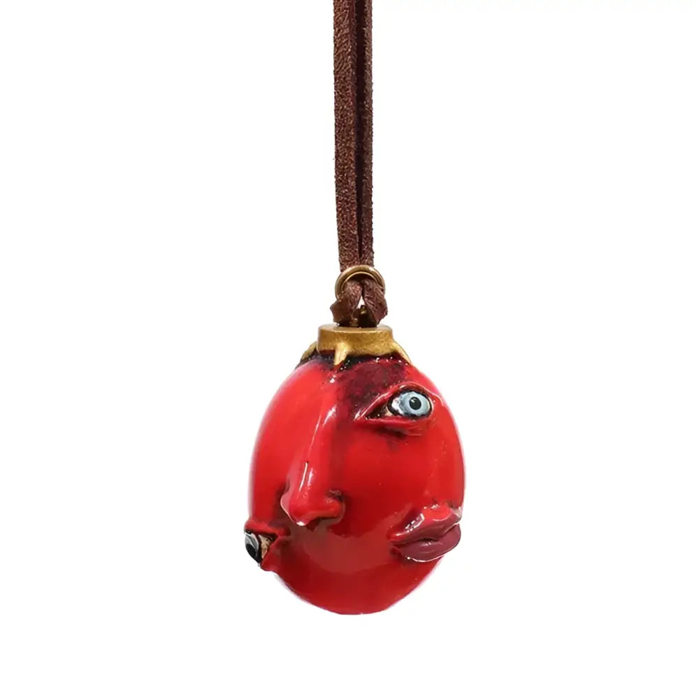 Berserk griffith behelit resin pendant in glossy red ceramic with detailed blue eyes and lips on brown leather cord