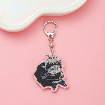 Clear acrylic black clover asta keychain featuring chibi white-haired character with green eyes holding a sword backpack charm