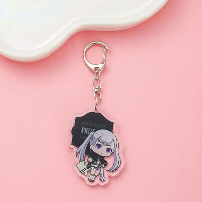 Clear acrylic black clover asta keychain featuring chibi silver hair character with purple eyes holding book black bloom noelie
