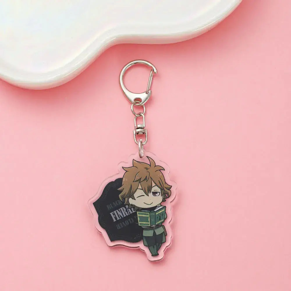 Clear acrylic black clover asta keychain featuring chibi brown haired character in green uniform winking with book