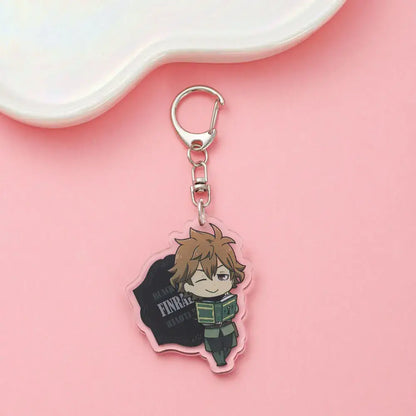 Clear acrylic black clover asta keychain featuring chibi brown haired character in green uniform winking with book