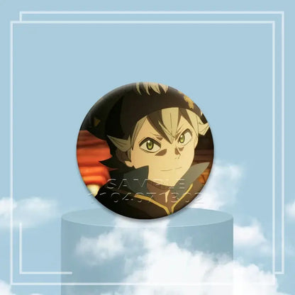 Black clover asta button pin featuring a young male anime character with green eyes black and gold hair on an orange sunset background