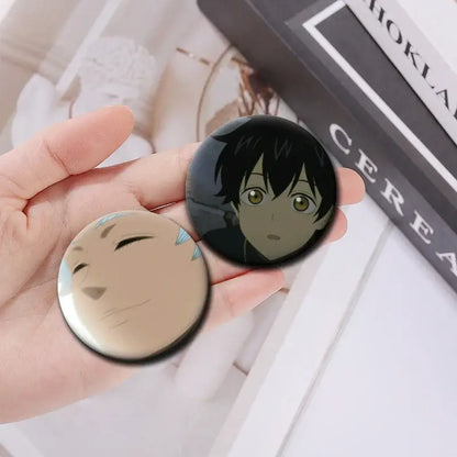 Two circular tinplate button pins featuring black clover asta with black hair and green eyes in an asta button pin set
