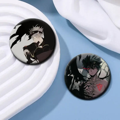 Two circular black clover asta tinplate button pins featuring a silver-haired and green-haired anime character design