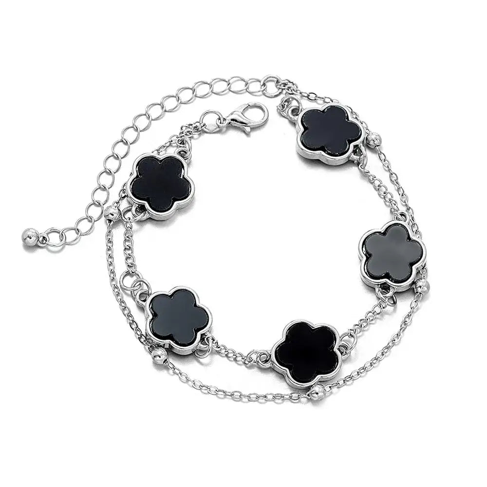 Silver chain wrist chain with five black clover asta charm outlines in polished metallic on black clover asta bracelet