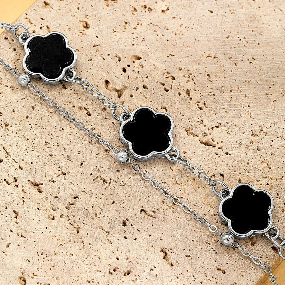 Silver chain wrist chain with three black clover asta charms featuring polished metallic edges