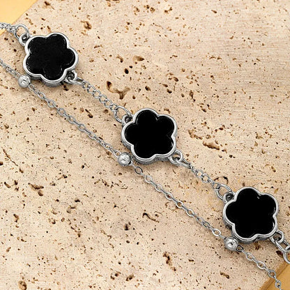 Silver chain wrist chain with three black clover asta charms featuring polished metallic edges