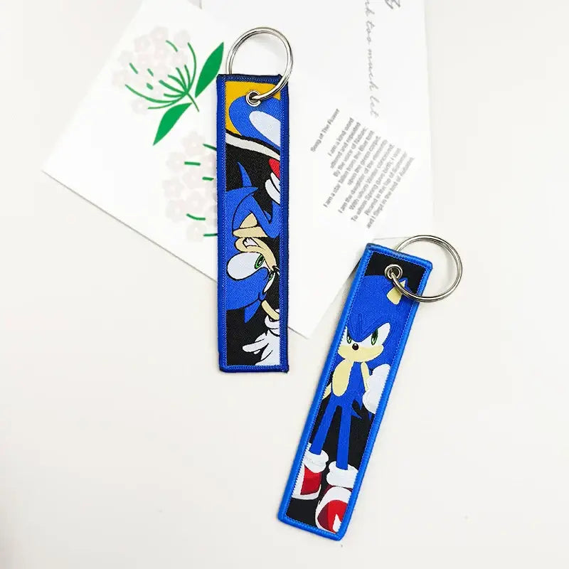 Blue embroidered sonic the hedgehog keychains with silver metal ring paired with black clover asta leather key tag