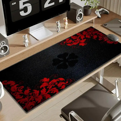 Black clover asta large desk mat with black and red floral pattern and textured surface for gaming use