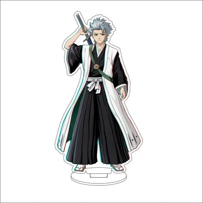 Bleach character acrylic standee featuring silver-haired anime figure in black and white robe with green sash on clear base