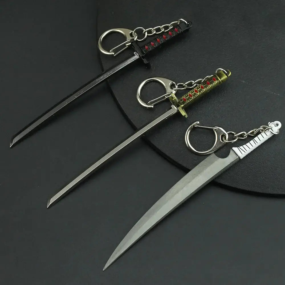 Three miniature zinc alloy sword keychains with metallic blades and black gold or silver intricate handles from bleach hitsugaya toushirou zangetsu collection