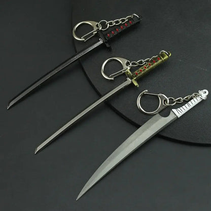 Three miniature zinc alloy sword keychains with metallic blades and black gold or silver intricate handles from bleach hitsugaya toushirou zangetsu collection
