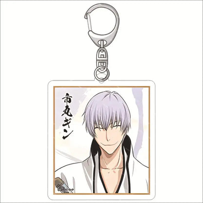 Silver-toned acrylic keychain featuring bleach ichigo with silver hair in white robe framed by a thin gold border