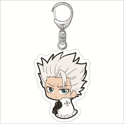 Chibi-style bleach ichigo acrylic keychain with spiky white hair and green eyes in white and black outfit acrylic keychain
