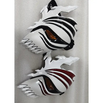 Two glossy white ichigo hollow masks with black stripes amber eye lenses and jagged edges for cosplay use
