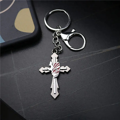 Silver metal cross keychain featuring a detailed ichigo hollow mask skull design with red and white enamel accents