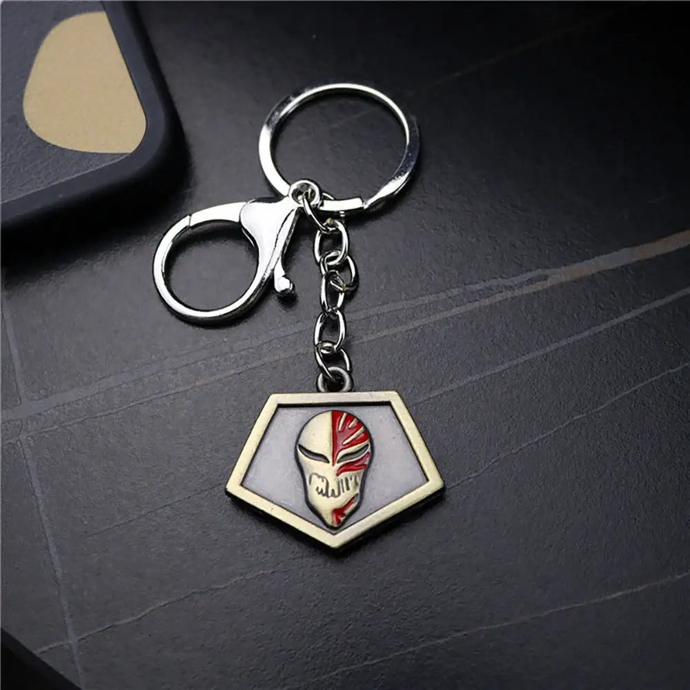 Silver and red enamel metal keychain with hexagonal ichigo hollow mask pendant featuring anime skull design