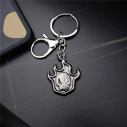 Silver metallic keychain with flame-shaped pendant featuring engraved ichigo hollow mask skull design metal accessory