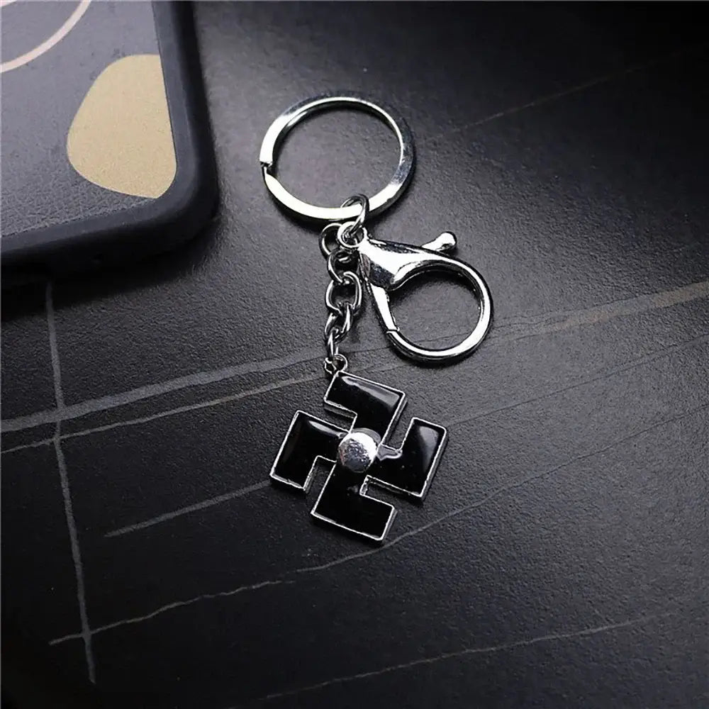 Silver-toned metal keychain featuring a black enamel ichigo hollow mask pendant with a central silver bead and clasp