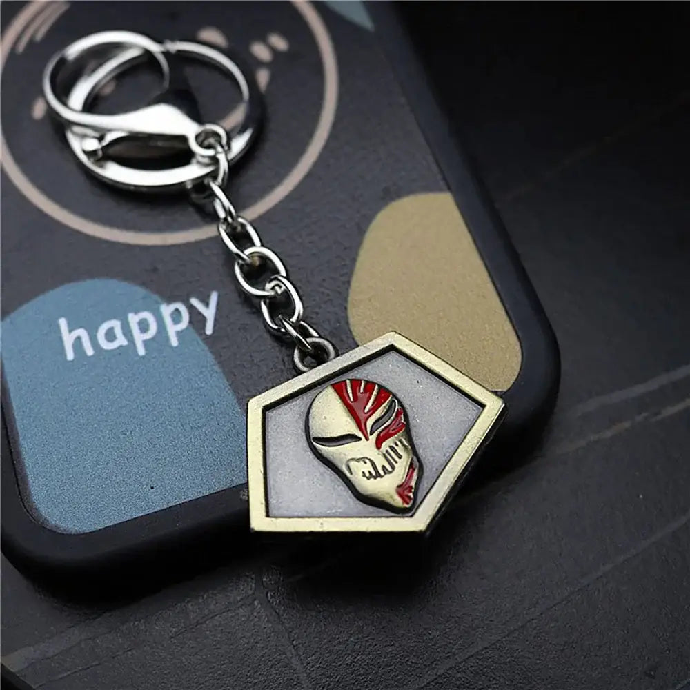 Metallic ichigo hollow mask keychain with hexagonal frame and red silver enameled skull design on metal ring and chain