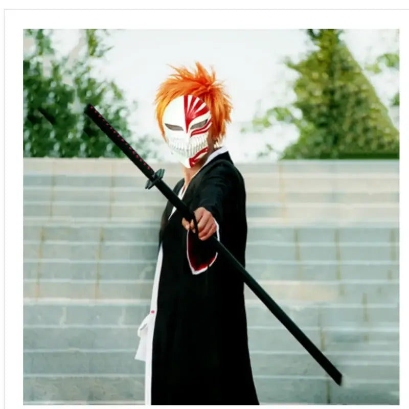 Orange and white stylized mask with red accents worn by cosplayer in bleach ichigo kurosaki cosplay costume set