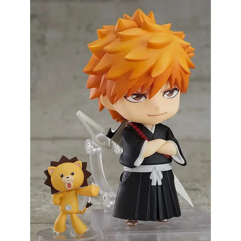 Bleach ichigo kurosaki pvc figure 10cm with orange spiky hair in black and white uniform standing with yellow lion companion