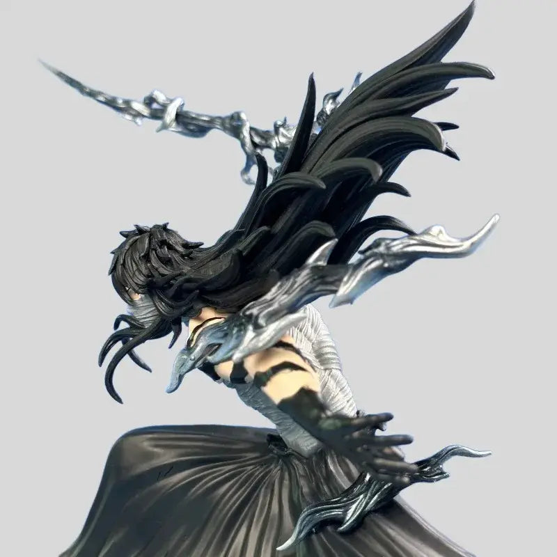 Black and silver pvc statue of bleach ichigo kurosaki with long dark hair wings and sword in moonless combat pose