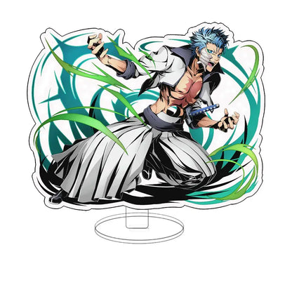 A dynamic acrylic keychain standee of bleach ichigo with spiky blue hair and swirling green energy effects