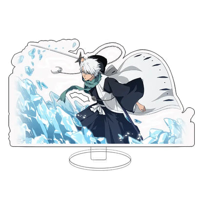 Clear acrylic keychain standee with white haired illustrated character in black outfit surrounded by blue ice shards