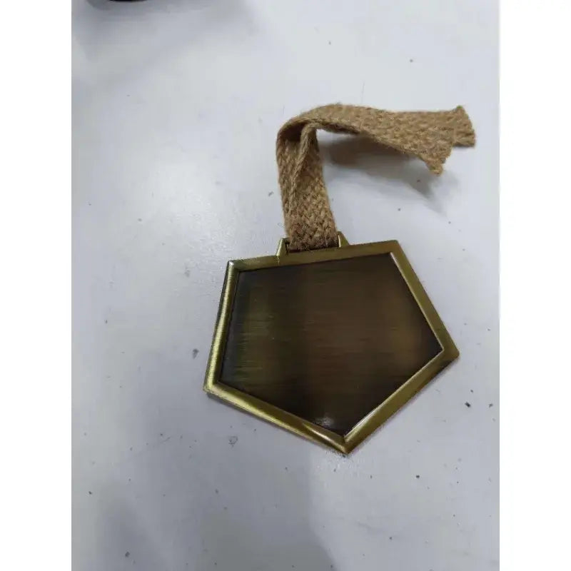 A hexagonal matte brass ichigo soul reaper badge with a woven jute hemp rope strap for cosplay use