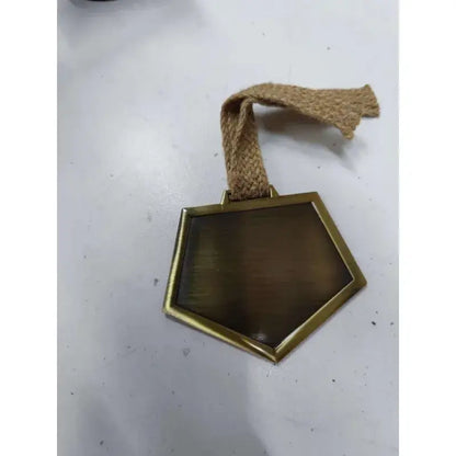 A hexagonal matte brass ichigo soul reaper badge with a woven jute hemp rope strap for cosplay use