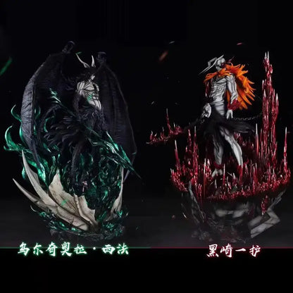 Two detailed resin figurines from bleach featuring dark-winged ulquiorra with green accents and orange-haired ichigo with red spikes