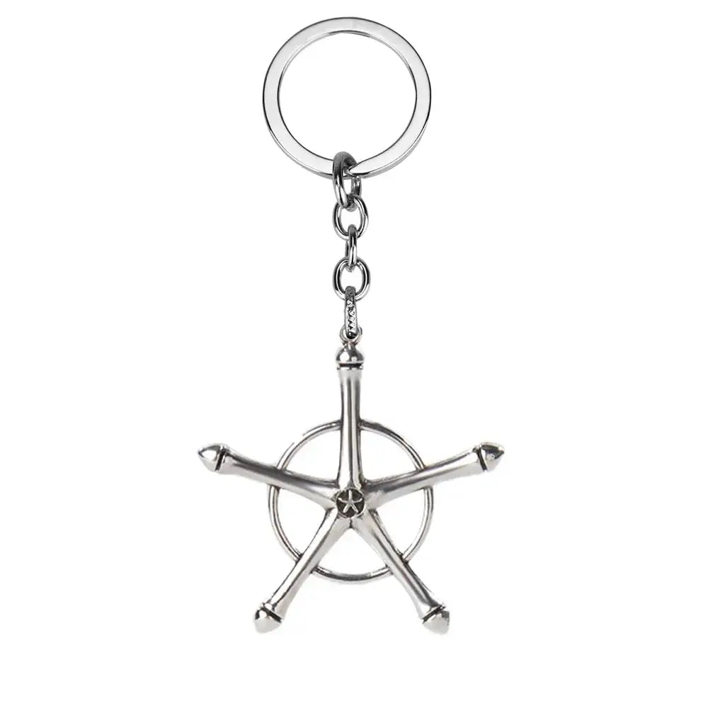 Silver metallic bleach ishida uryuu keychain pendant with a stylized ship’s wheel design and five spokes