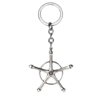 Silver metallic bleach ishida uryuu keychain pendant with a stylized ship’s wheel design and five spokes