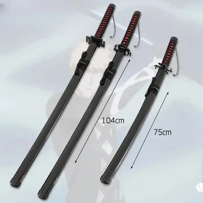 Three black plastic kurosaki ichigo samurai swords with red wrapped grips and silver chains measuring 104cm and 75cm
