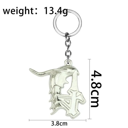 Silver metallic ulquiorra cifer mask keychain with ornate cut-out metal pendant and polished finish