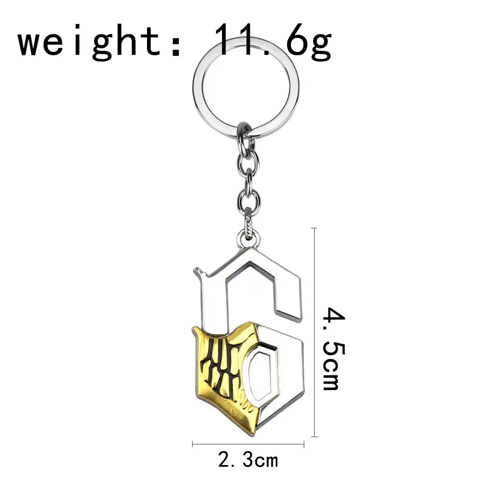 Silver and gold two-tone metal keychain featuring a detailed ulquiorra cifer mask stylized s emblem pendant