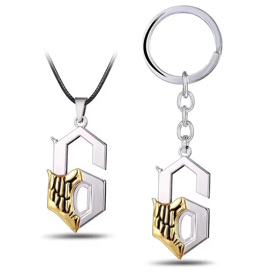 Silver and gold two-tone metal keychain pendant shaped like a stylized ulquiorra cifer mask with intricate skeletal design