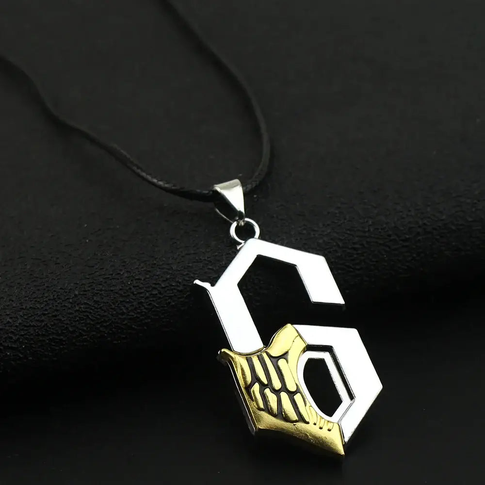 Silver and gold two-tone ulquiorra cifer metal pendant necklace with stylized g and skeletal hand on black cord