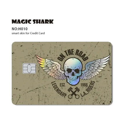 Vintage-style blue eyes white dragon card skin with central skull, rainbow wings, and on the road text for credit cards