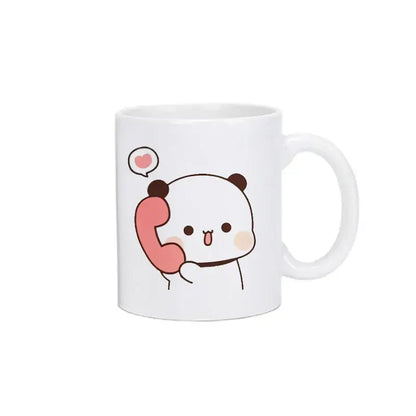 White ceramic bubu dudu panda bear christmas mug featuring a cute panda holding pink telephone with heart bubble