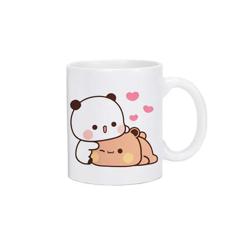 White ceramic mug featuring bubu dudu panda and tan bear hugging with pink hearts kawaii cup design