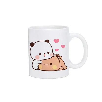 White ceramic mug featuring bubu dudu panda and tan bear hugging with pink hearts kawaii cup design