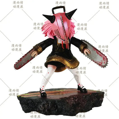 Pink-haired anya forger chainsaw man desktop ornament in black and gold outfit holding two chainsaws on rocky base