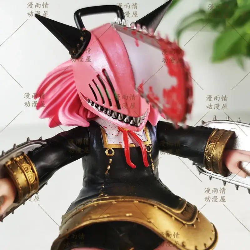 Pink and black chainsaw mask garage kit figurine with gold accents from chainsaw man anya forger 2d animation statue