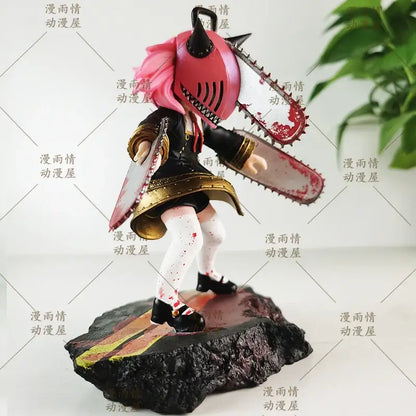 Chainsaw man anya forger garage kit features pink-haired anime figure with red chainsaw helmet and blood-splattered chainsaws on rocky base