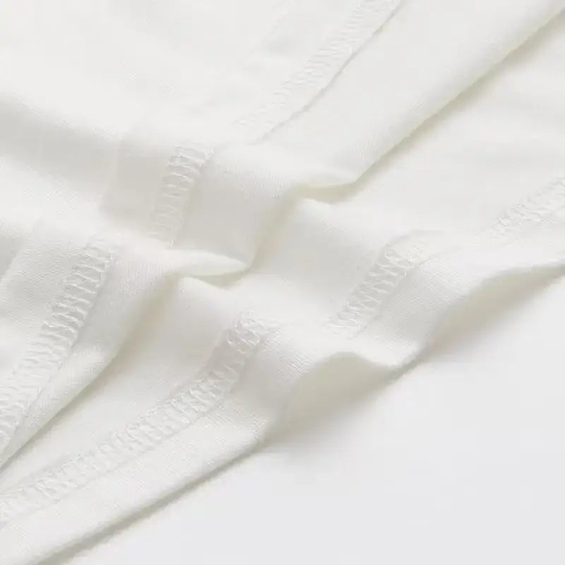White fabric with delicate stitched edges on the chainsaw man denji oversized fit soft cotton t-shirt