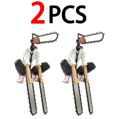 Two identical chainsaw man denji pvc figures wearing white shirts and black pants holding metallic silver chainsaws